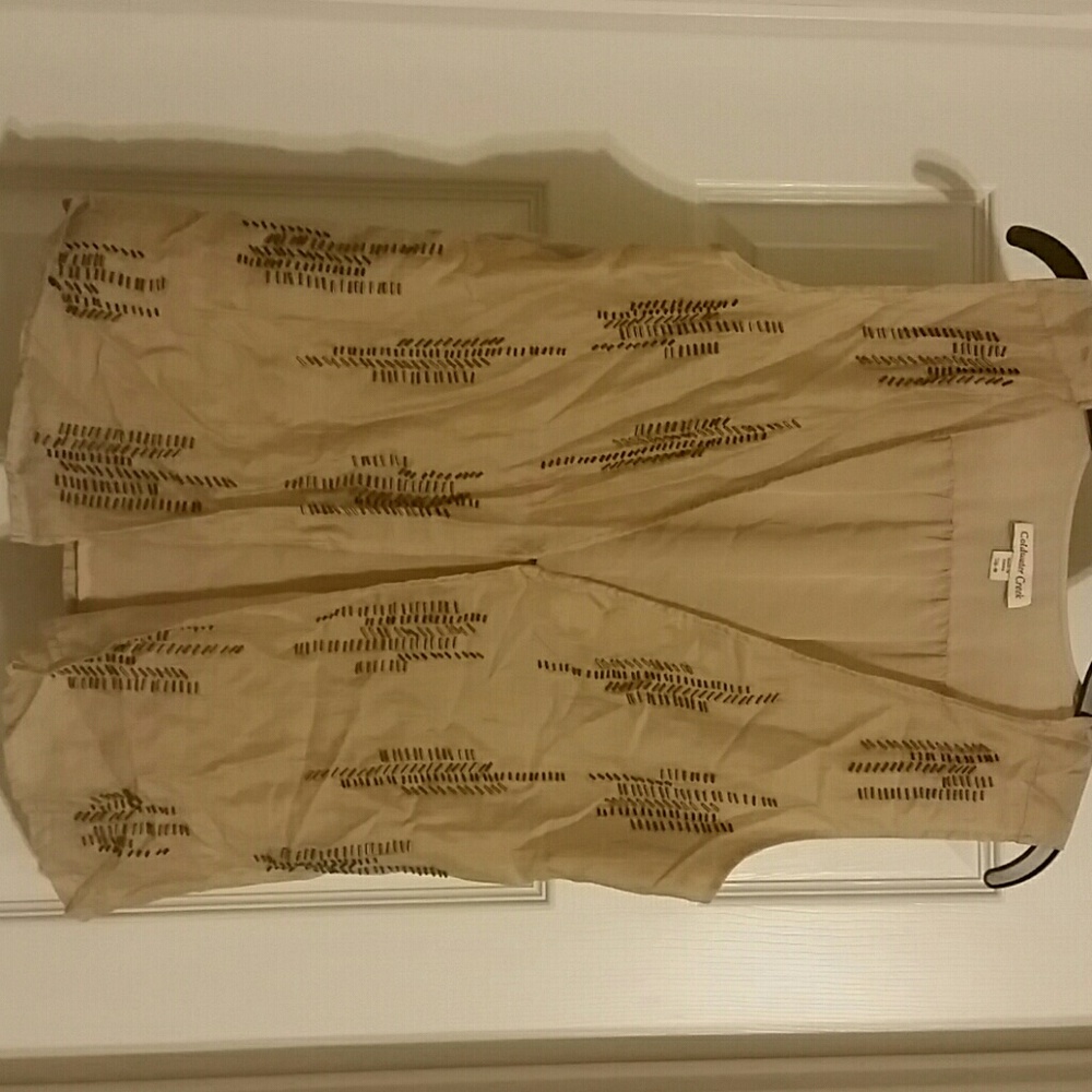 Tan decorative flowy sleeveless cover